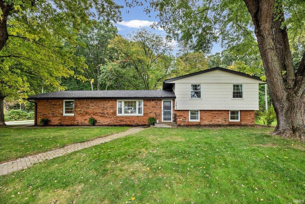 141 Indian Rock Drive, West Lafayette, brick and white siding under mature trees
