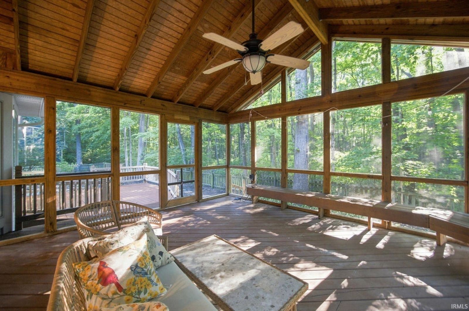 Screened porch with a wood ceiling, looking into the trees