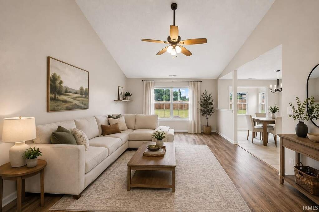 Great room with a vaulted ceiling and a ceiling fan